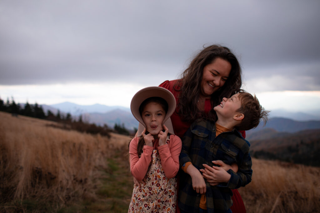 mother and children hug and play silly on roan Mountain
